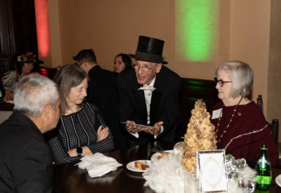 Kay Lachter with Rebecca and Edwin Menendez, and magician