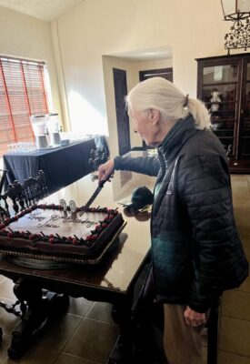 Jane Goodall cutting her 90th birthday cake